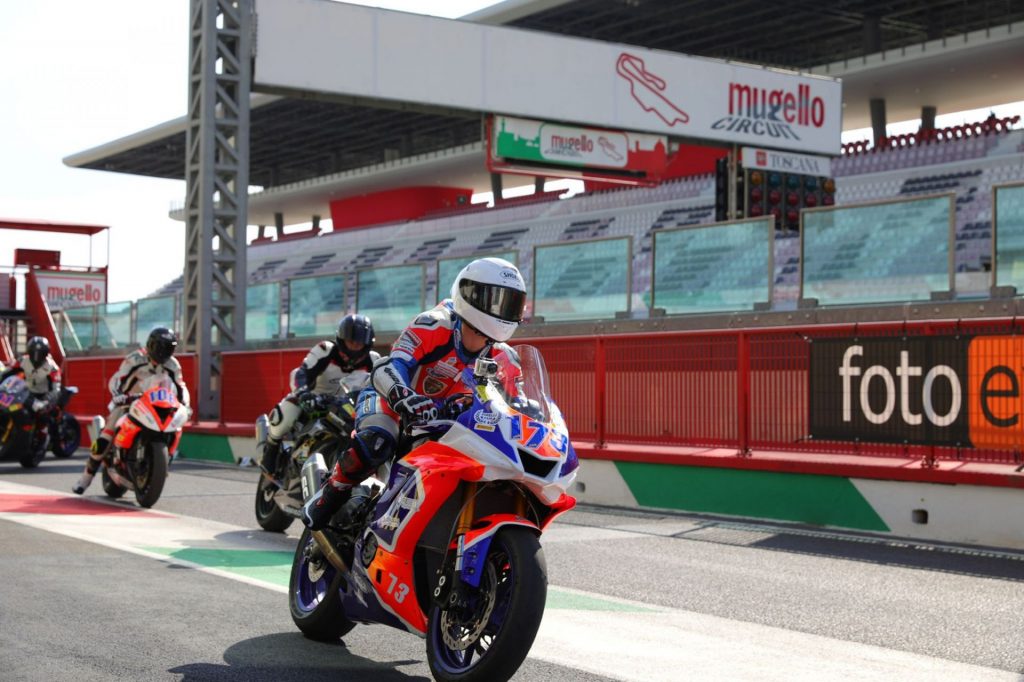 Photo of a motorbike race with an empty stand in the background