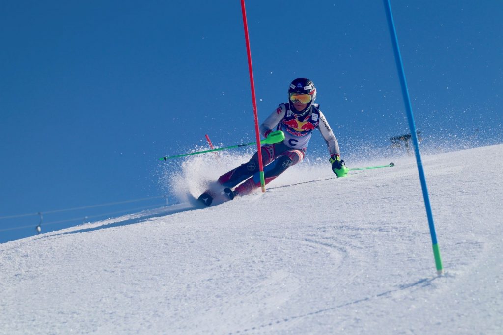 Photo of student, Lukas, skiing downhill between two gates