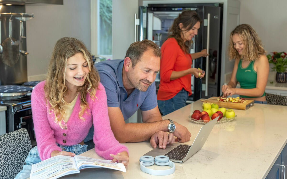 A Levels students studying in the kitchen with her family