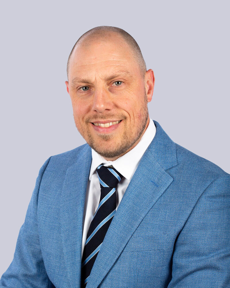 Studio portrait of King's InterHigh SEN Lead, Ray Boxall, against a white background.